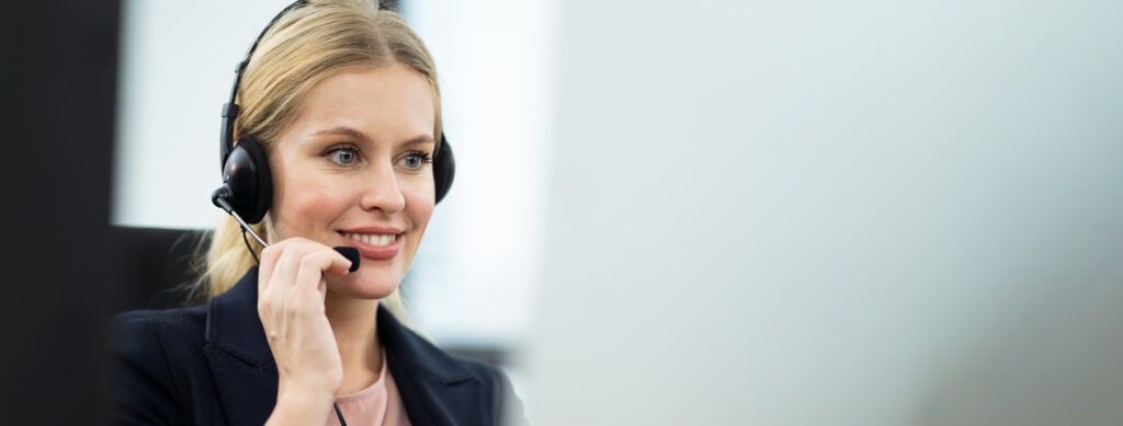 Smiling Female Receptionist With Headset Representing Ruby Receptionist's Australian Virtual Receptionist Services