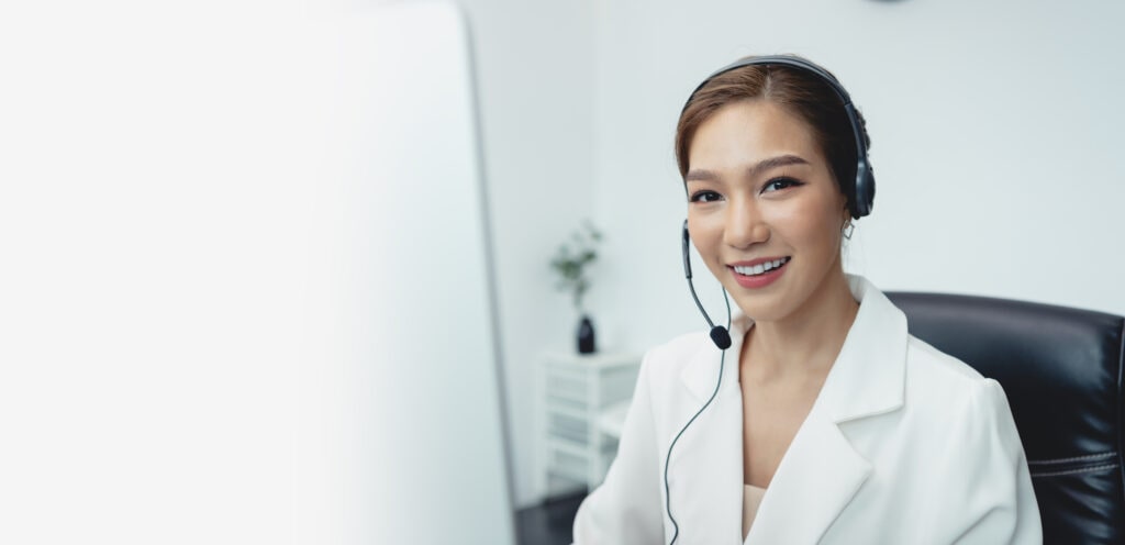 Receptionist Wearing A Headset And Working, Representing Accounting Phone Answering Services Offered By Ruby Receptionist.