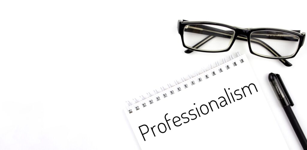 Reading Glasses And Notebook With The Word 'Professional' On Ruby Receptionist's After-Hours Call Answering Page.