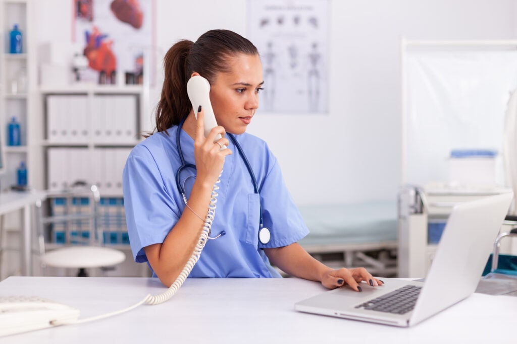 Medical Practitioner At Allied Health Answering Phone Calls, Represented By Ruby Receptionist's Virtual Receptionist Services.