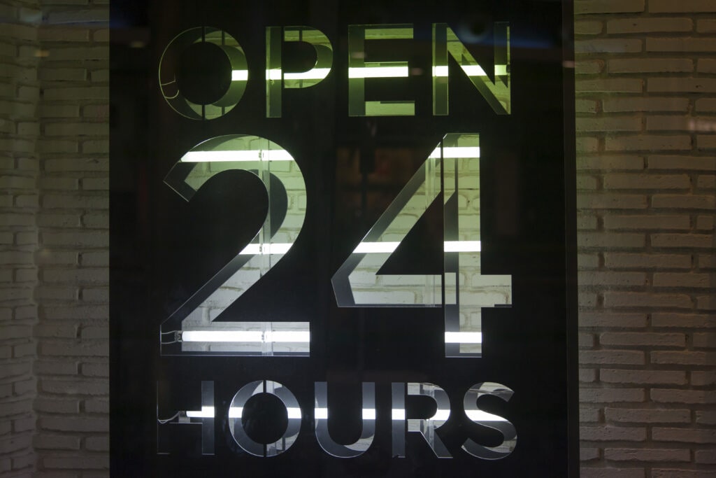 Ruby Receptionist Corporate Answering Services Sign, Indicating 'Open 24 Hours' At A Store Location.