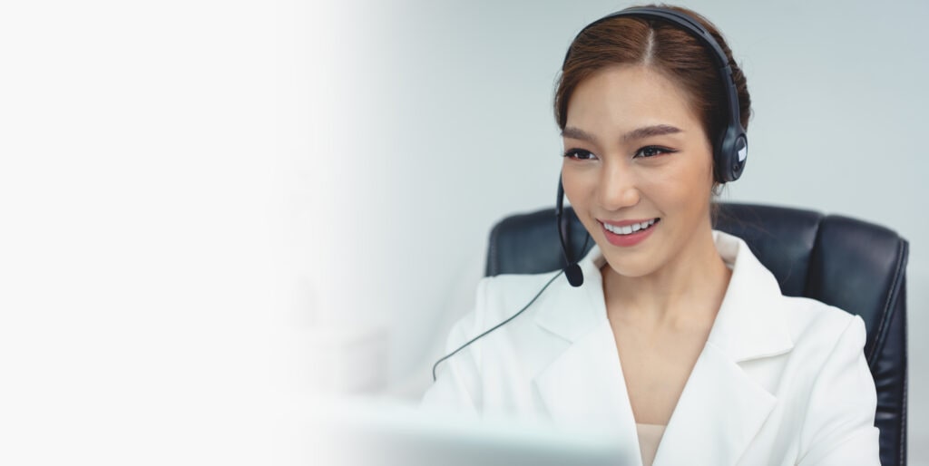 A Receptionist Wearing A Headset, Working Diligently, Representing Ruby Receptionist's Holiday Phone Answering Services.