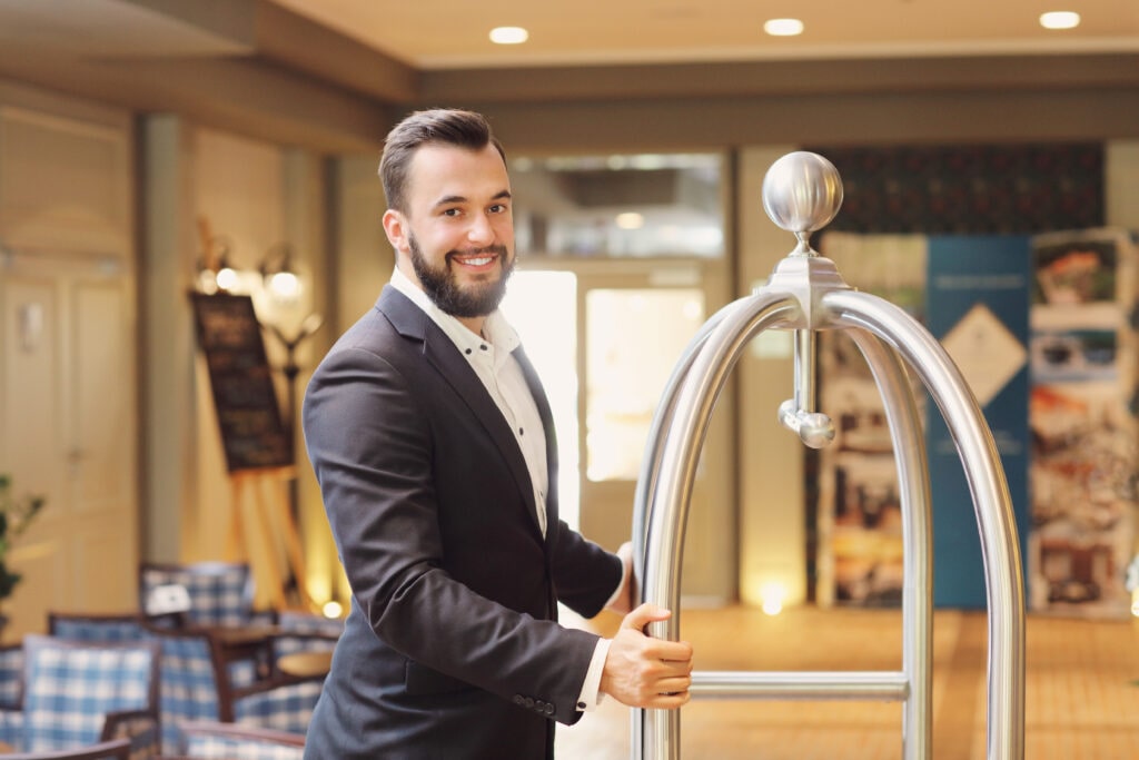 Image Of A Bellboy In A Hotel Highlighting The Benefits Of Phone Answering In The Hospitality Industry.