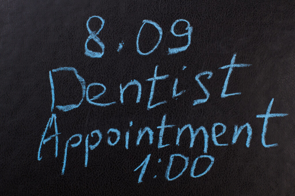 Dentist Appointment Reminder Chalkboard In A Medical Office, Highlighting Ruby Receptionist's Virtual Services